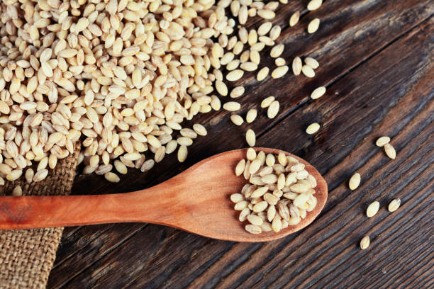 istock Pearl barley grain seed on wooden background 839021408