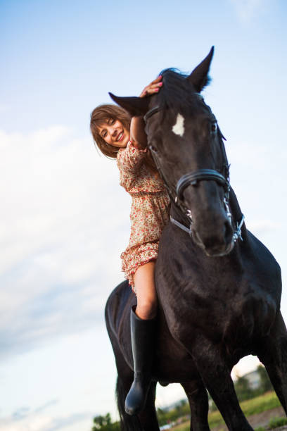istock young woman riding her horse 839024352