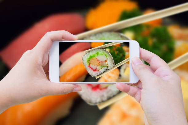 istock sushi maki in chopsticks 839025068