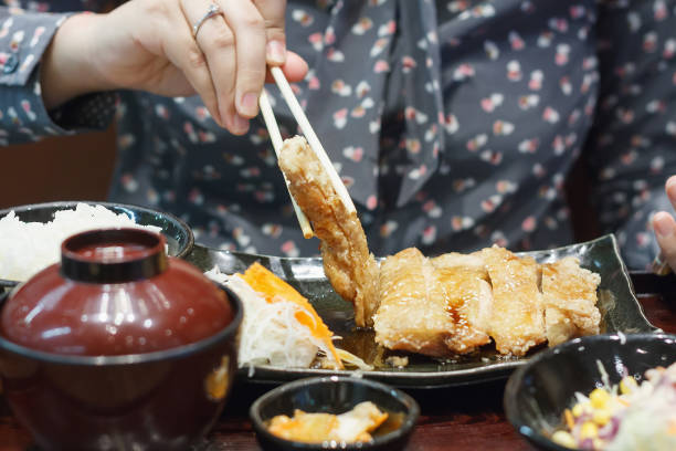 istock woman eating teriyaki chicken 839028266
