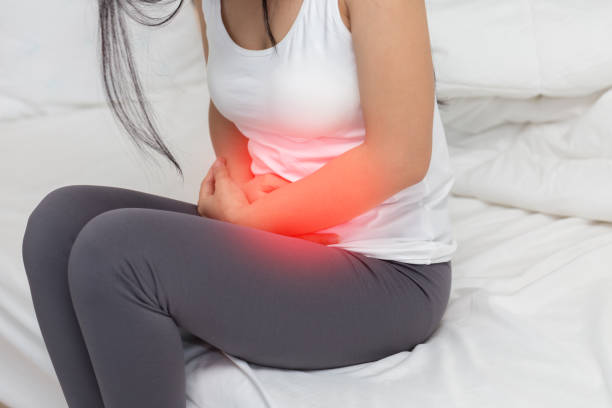 stomachache in young Asian woman stomachache in young Asian woman abdominal pains stock pictures, royalty-free photos & images