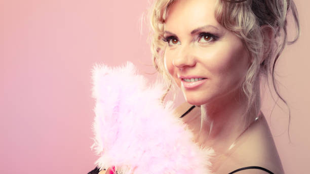 istock Woman holding carnival feather fan in hand. 839030040