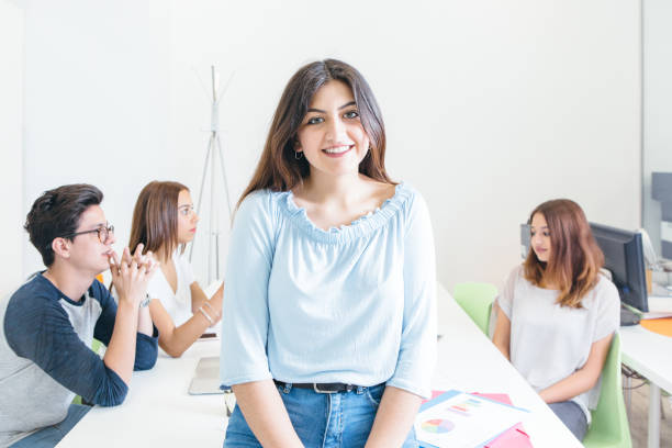 istock Content woman in office with students 839034614