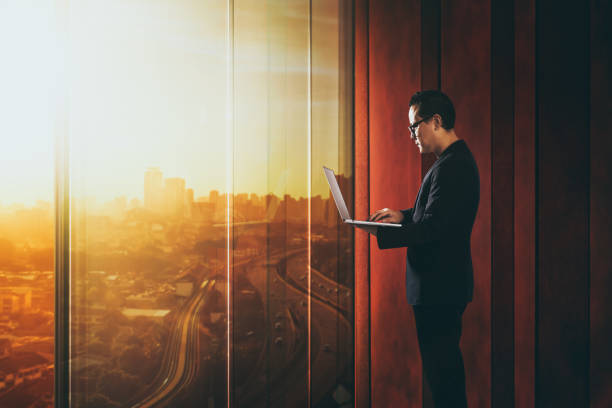 istock Businessman using laptop with generic office background , night scene . 839039314