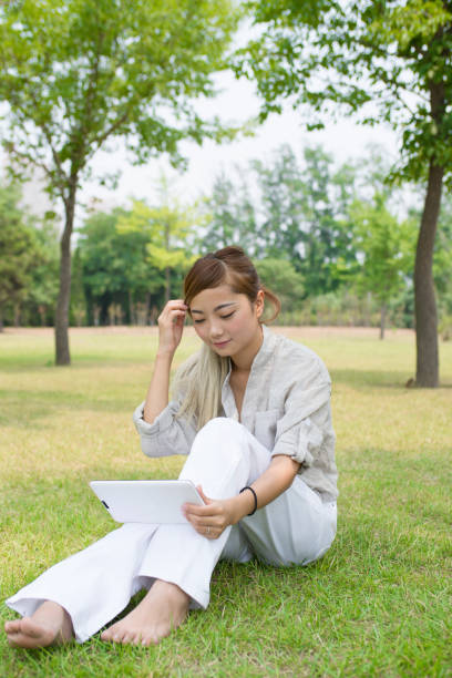 istock girl on the grass to rest 839044316