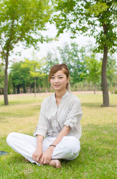 istock Asian young woman on the grass 839044330