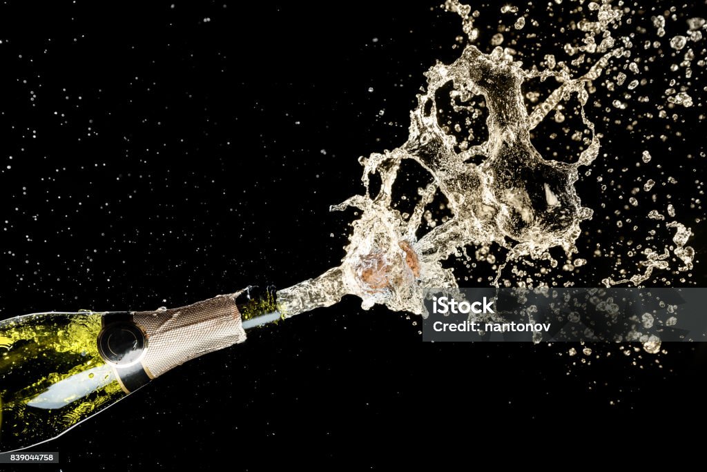 Celebration and holiday theme. Champagne splashes on black background Celebration and holiday theme. Champagne splashes on black background. Champagne Stock Photo