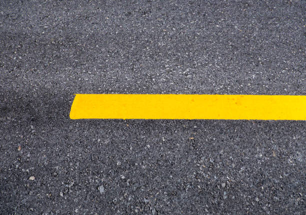 istock Close up asphalt surface of road divide yellow lines 839045606