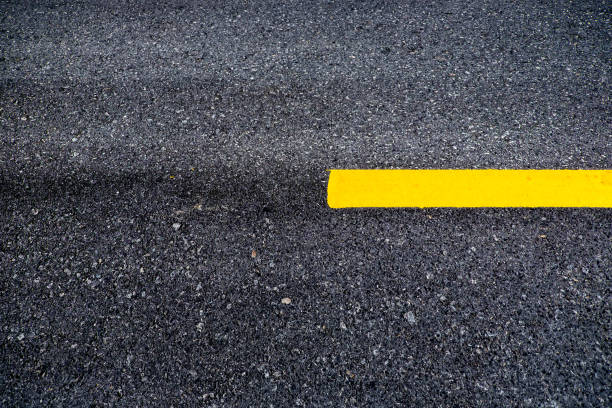 istock Close up asphalt surface of road divide yellow lines 839045620