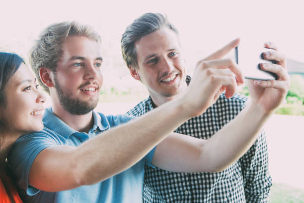 istock Happy young people photographing for social network 839055930