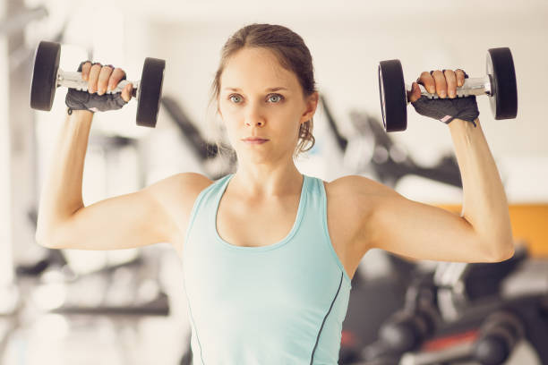 istock Serious Woman Training With Dumbbells in Gym 839056346