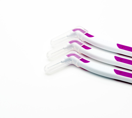 Three interdental brush with cover isolated on white background with copy space