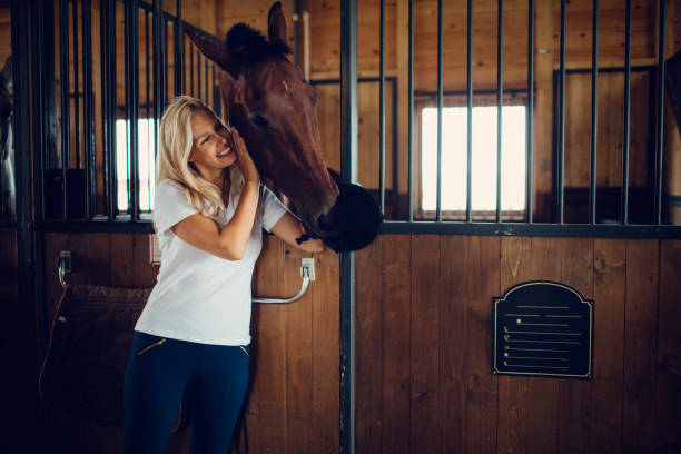 istock Woman stroking her horse 839059992