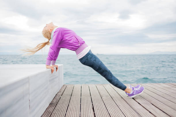 Young woman jogging at sea cost