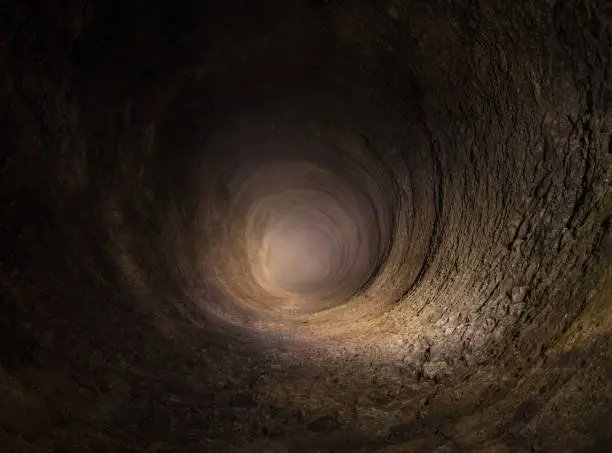 The hole of an ancient stone well .