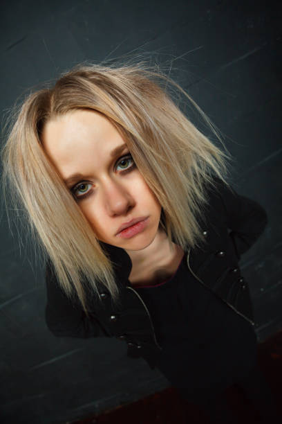 istock Disheveled girl posing on black background 839088802