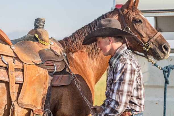 istock Young Man Preparing His Horse 839096894