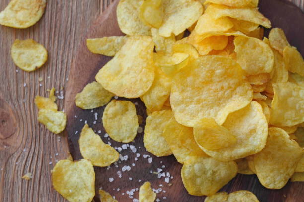istock Potato chips on the table. Fast food. 839103294