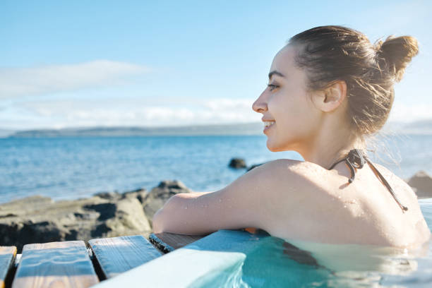 istock Woman relaxing in pool outside 839105086