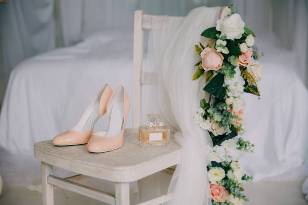 bridal accessories on a white chair with flowers, perfume shoes. clothing concept - wedding dress bouquet wedding bride imagens e fotografias de stock