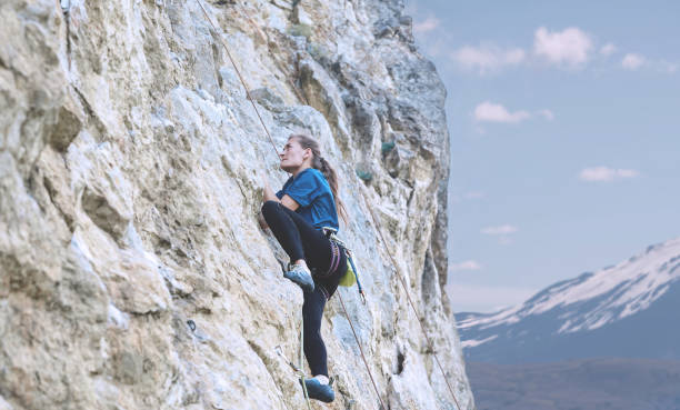 istock woman rock climber on the cliff 839112972
