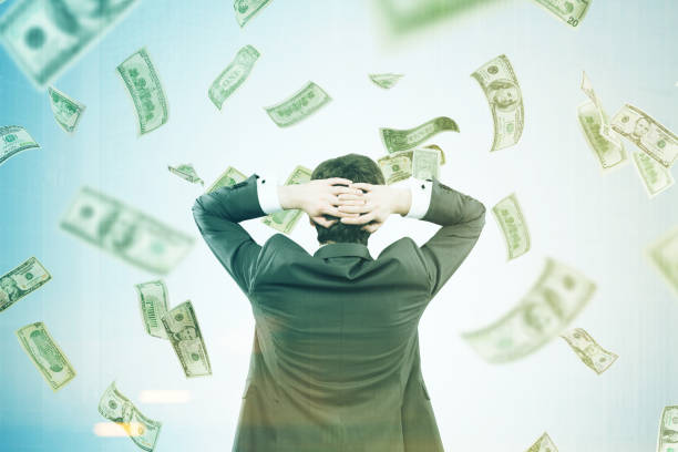 istock Man with hands behind his head in a money flow 839119824