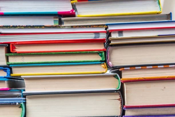 istock Stack of books on a shelf, multicolored book spines. 839127358