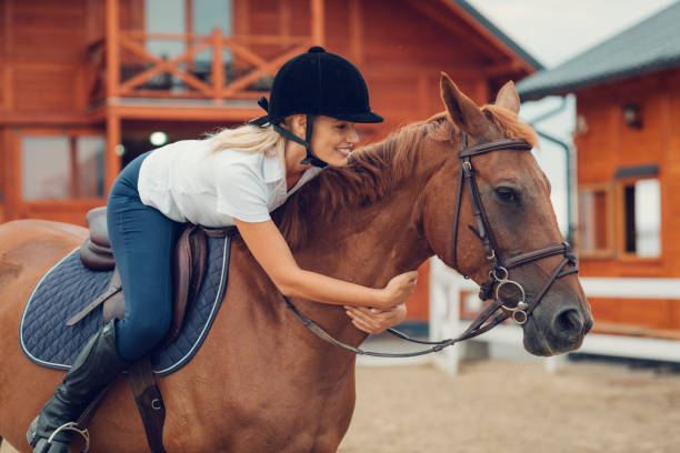 istock Woman in a barn with her horse 839127712