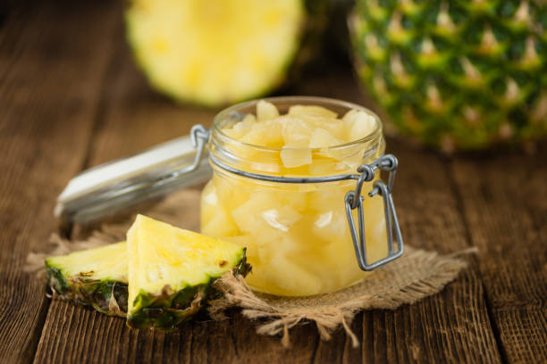 istock Portion of Chopped Pineapple (preserved) on wooden background, selective focus 839131516