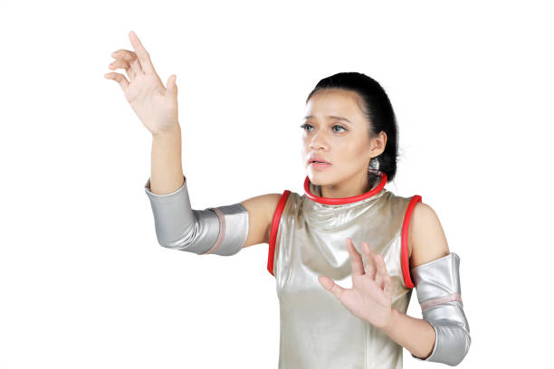 Asian woman wearing a futuristic costume while touches something on the transparent screen, isolated on white background