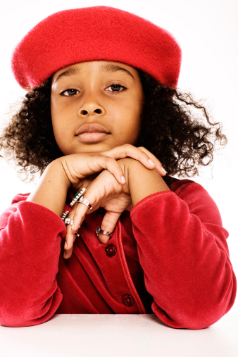 portrait of a young african american girl wearing red beret