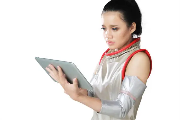 Asian woman wearing a futuristic costume while using a digital tablet, isolated on white background