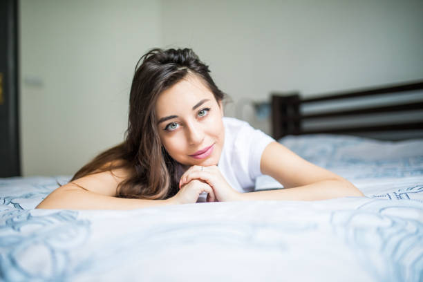 A woman lying on the bed and smiling