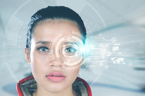 Close up of a futuristic woman looking at virtual graphics on her eyes