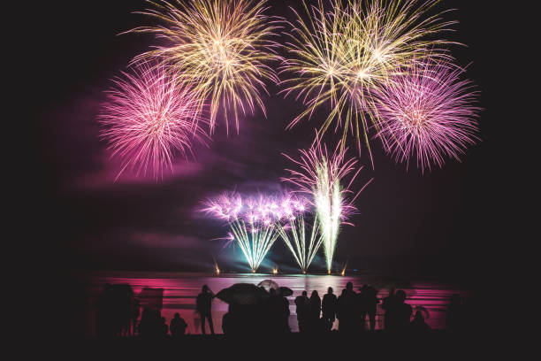 istock Beautiful large and colorful fireworks with unrecognizable crowd silhouettes people watching the show 839153628
