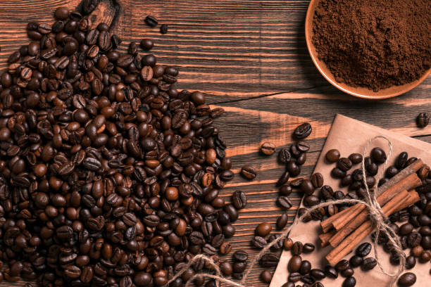 istock Coffee beans, cinnamon sticks and ground coffee on rustic wooden 839161360