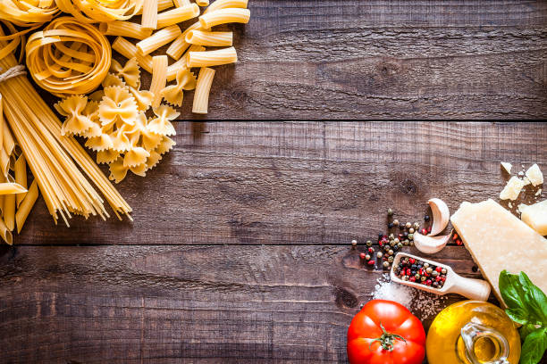 istock Raw pasta and ingredients on rustic wooden table with copy space 839166834