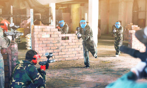 Teams faced on the battlefield in the arena of paintball. Cheerful positive teams faced on the battlefield in the arena of paintball. paintball photography stock pictures, royalty-free photos & images