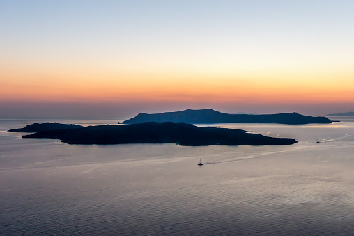 Horizontal color image of famous volcano in Santorini during romantic sunset.