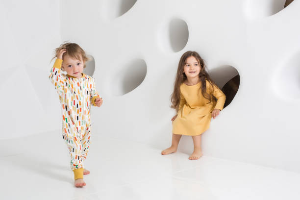 istock Children sisters play together on white background 839171324