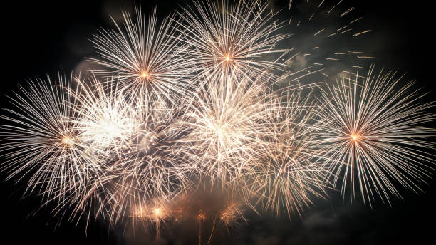 Beautiful large and colorful fireworks display show close-up on dark background stock photo