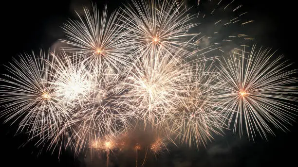 Photo of Beautiful large and colorful fireworks display show close-up on dark background