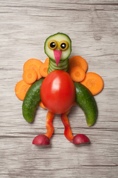 istock Peacock made of vegetables on wooden background 839207626