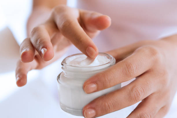 touching with softness woman's hand touching on the cream for applying cream stock pictures, royalty-free photos & images