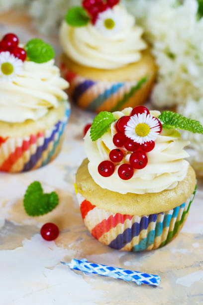 istock Gentle cupcake with cream and berries nd a candle a light background 839218124