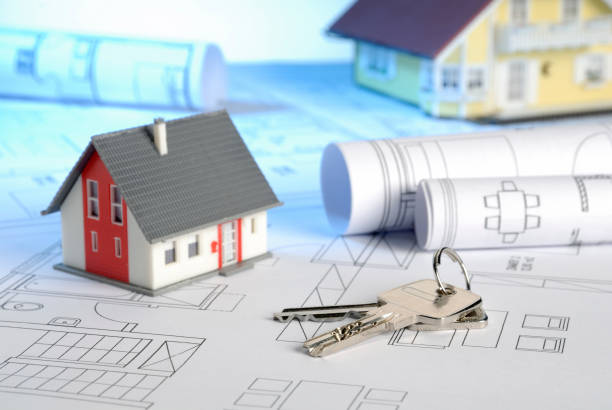 istock Building plans with house keys and houses 839223648