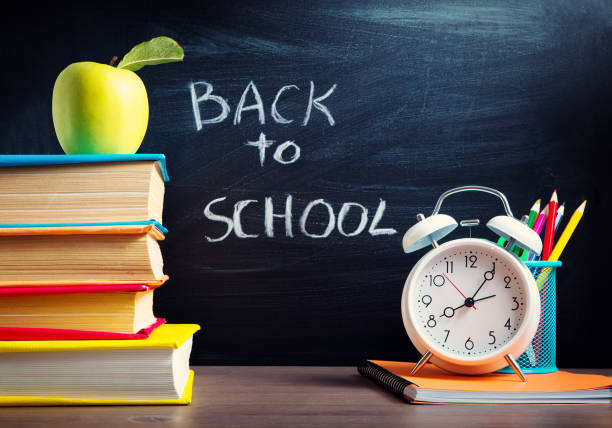 istock school accessories on the table with blackboard background 839232286