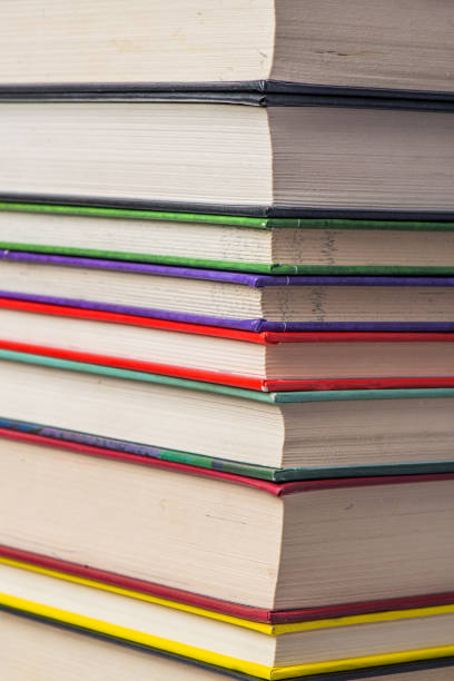 istock Stack of books on a shelf, multicolored book spines. 839279490