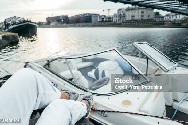 Woman Sits On Piar Looking On The River Stock Photo - Download Image Now - Amphibious Vehicle, Bedpan, Copy Space