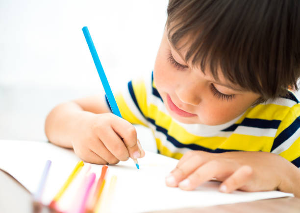 istock The child paints with colored pencils 839290718